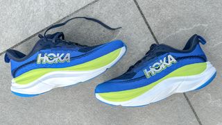 Hoka Skyflow running shoes on a sidewalk