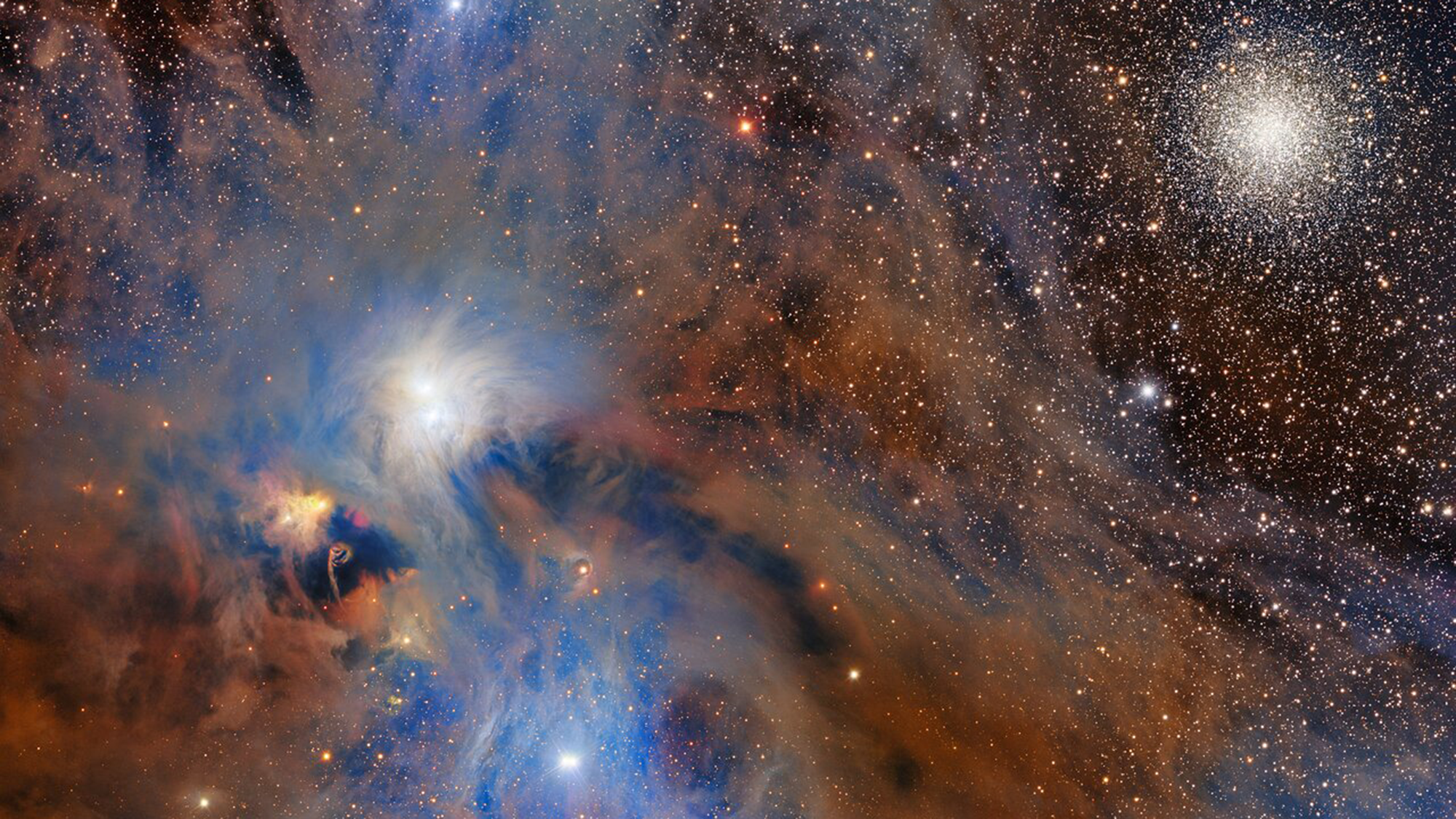 A swirl of rust-colored gas sparkles with stars in a deep space images.