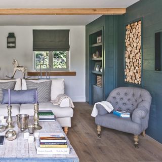 teal rustic living room with log storage