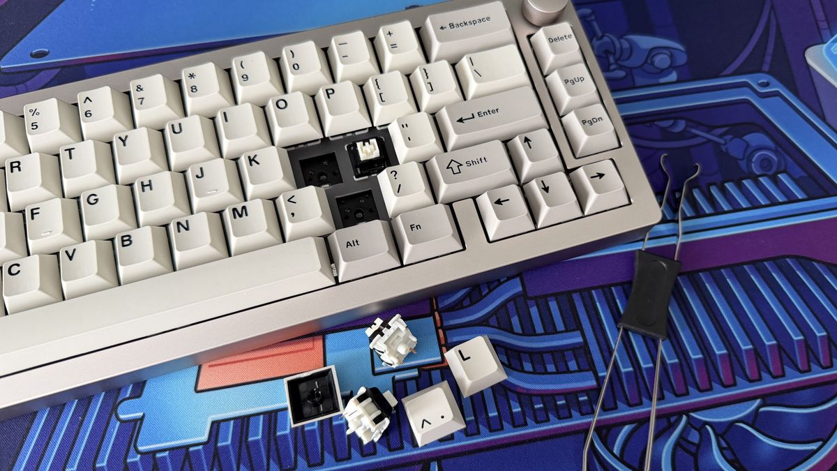 The Epomaker 65 with multiple keycaps and switches removed; the switches and the tool used to remove them sit beside the keyboard.