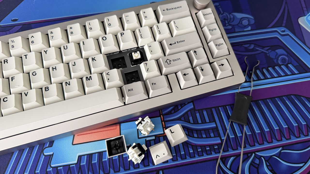 The Epomaker 65 with multiple keycaps and switches removed; the switches and the tool used to remove them sit beside the keyboard.