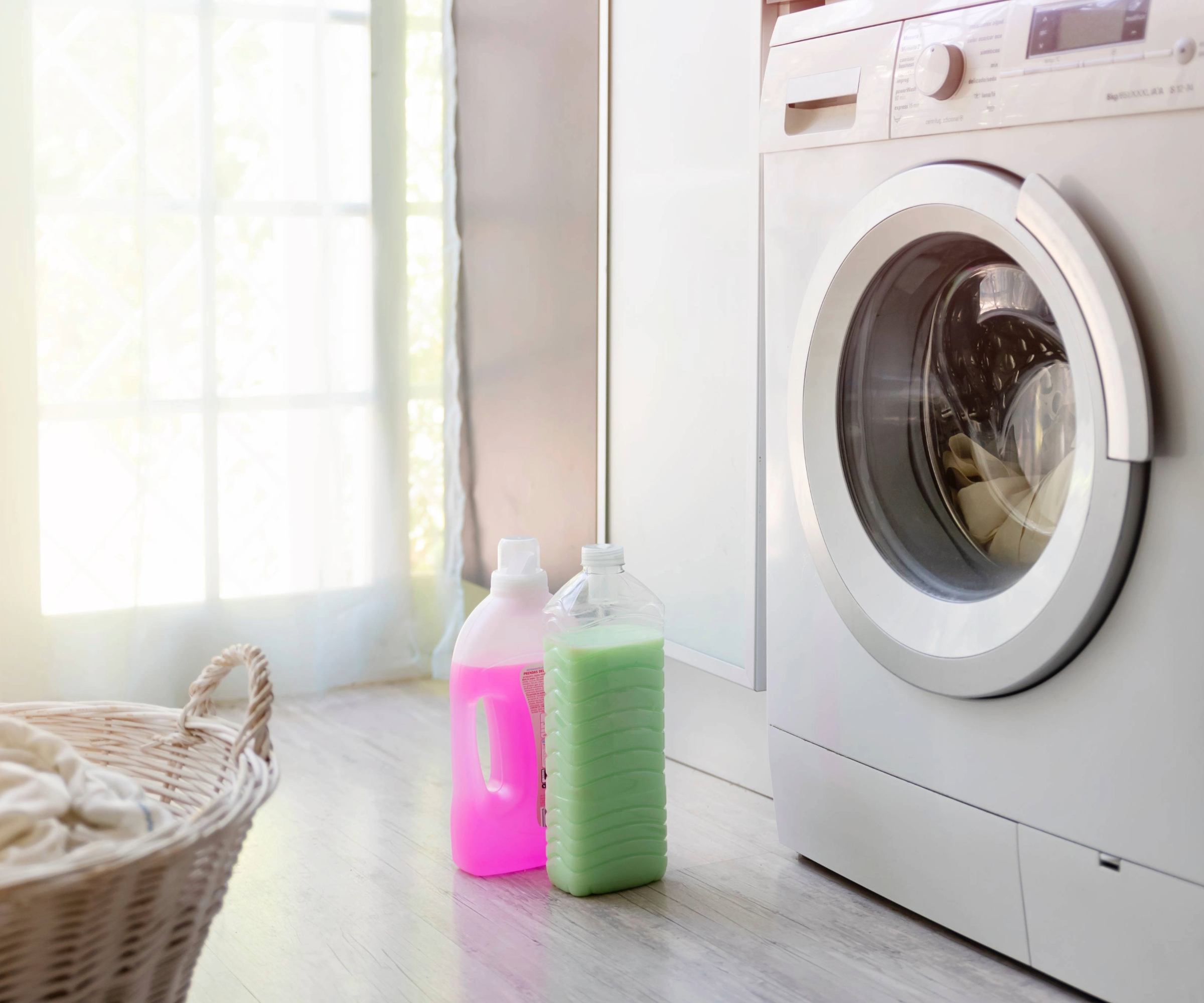 Washing machine with two bottles of detergent and a bakset