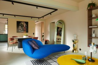 A living room with a blue daybed