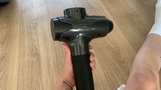 Lairlux massage gun being tested on leg