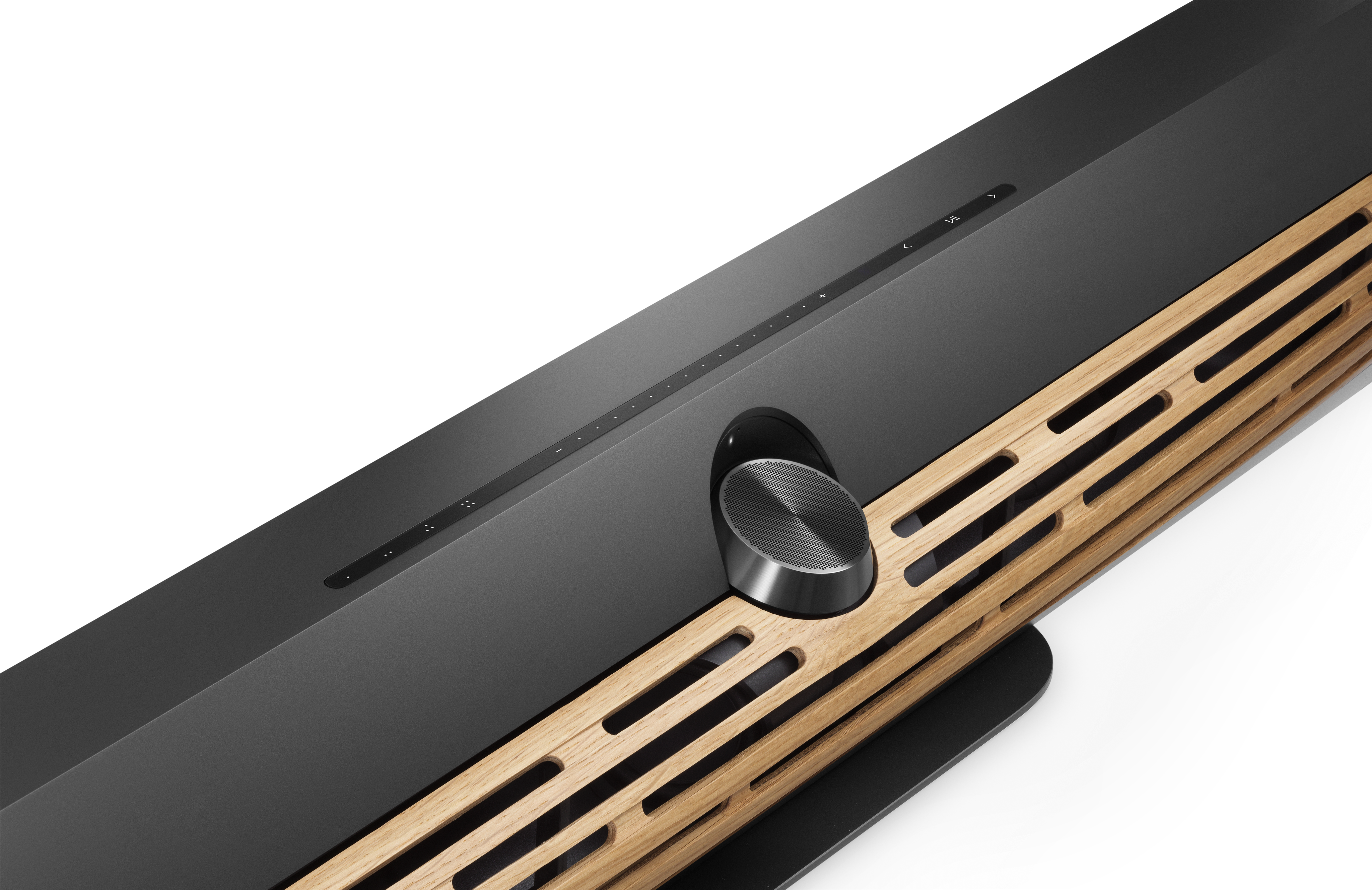 Close up of the Bang &amp;amp; Olufsen Beosound Premiere in black with wooden grille on a white background