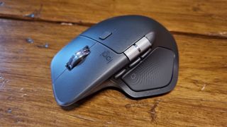 The Logitech MX Master 4 productivity mouse on a wooden desk