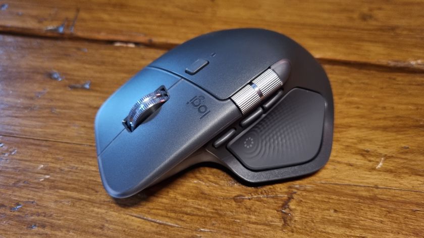 The Logitech MX Master 4 productivity mouse on a wooden desk
