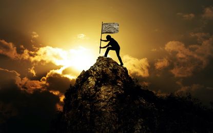 Man holding flag on the peak of mountain and sunset outdoor on nature , success winner business concept