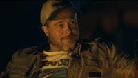 James Belmont (Brad Pitt) looks over at someone in Heart of the Beast.