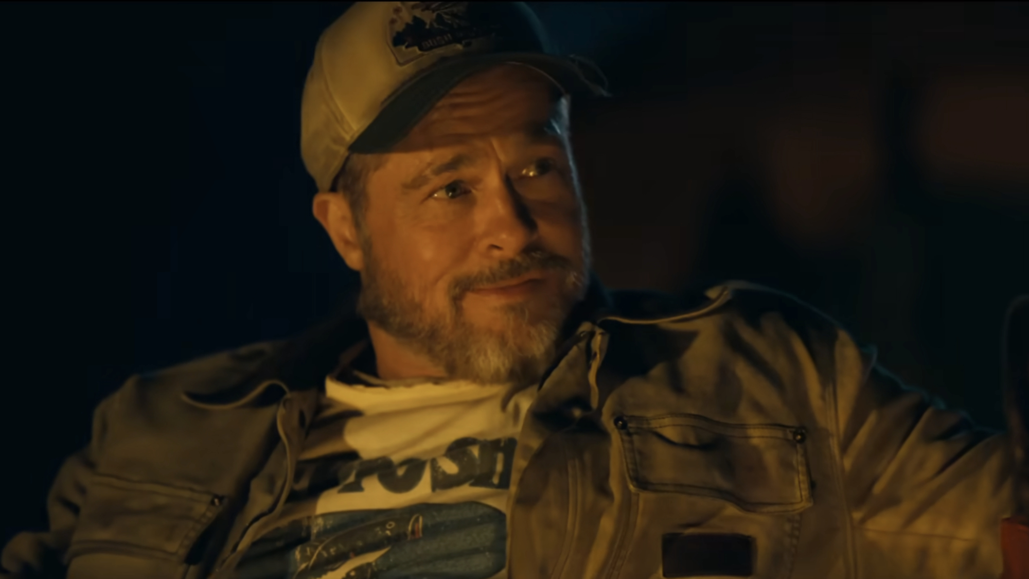 James Belmont (Brad Pitt) looks over at someone in Heart of the Beast.