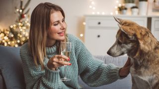 Lady drinking champagne with her dog