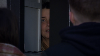 Charity Dingle peeks through the door and tells Noah Dingle to leave.
