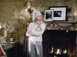 cameron diaz wearing a hat and sweater in a cozy cabin in The Holiday