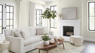 White living room with all white furnishings showcasing Behr's blank canvas as a key 2023 paint color trend
