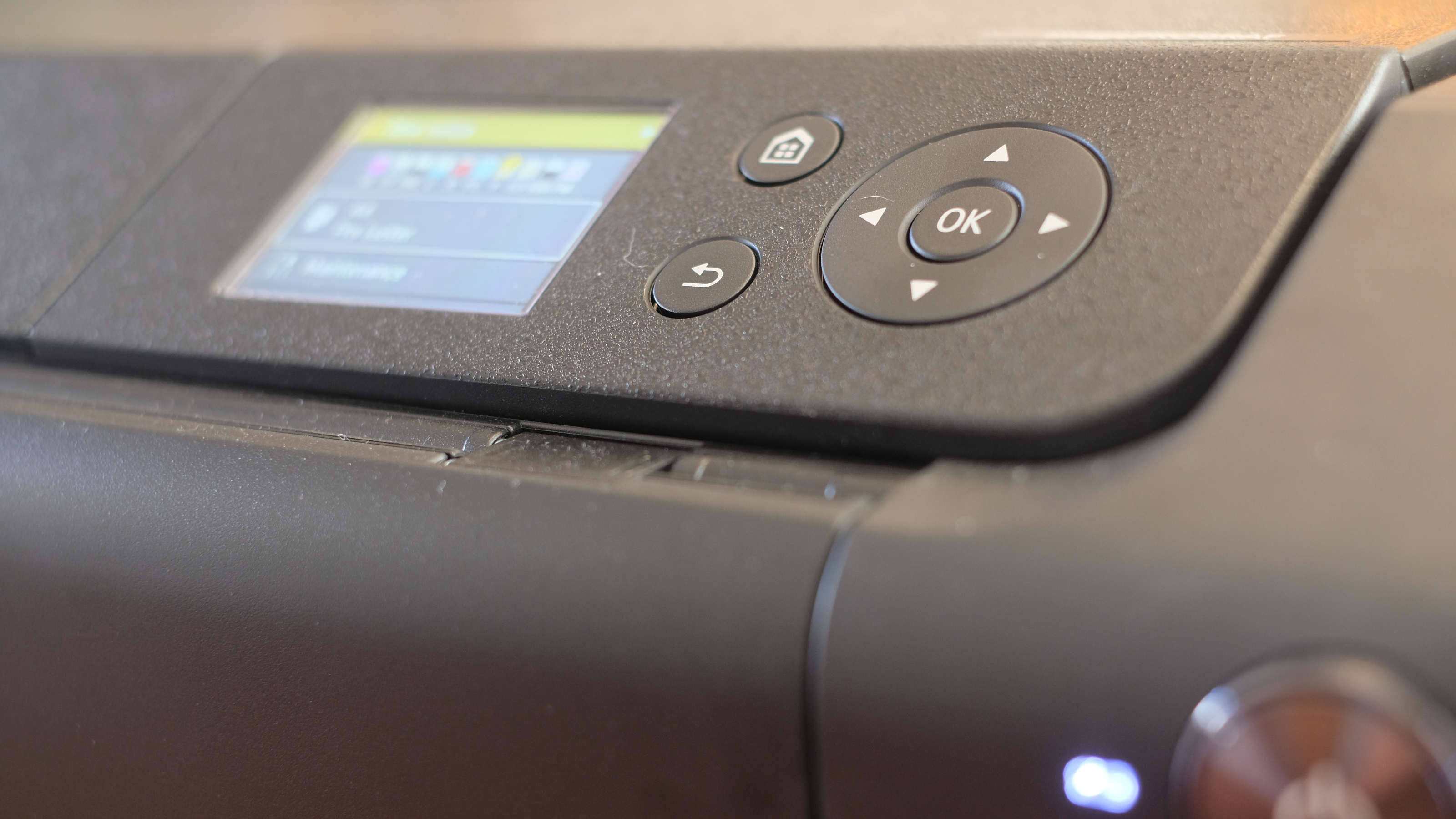 A photograph of the Canon imagePROGRAF PRO-310 printer with buttons and screen visible.