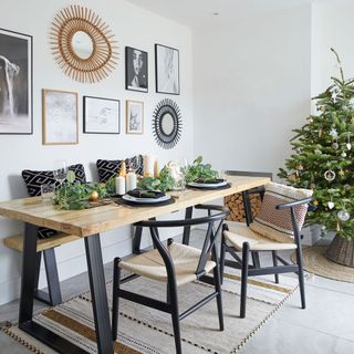 white dining room with wooden table with black legs and wishbone chairs