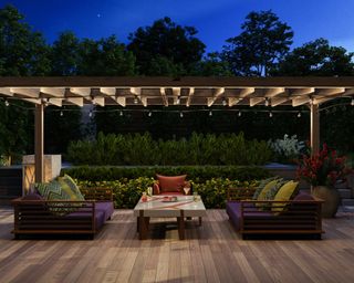 Modern Decking With Sofa, Armchair, Coffee Table And Garden View Background At Night