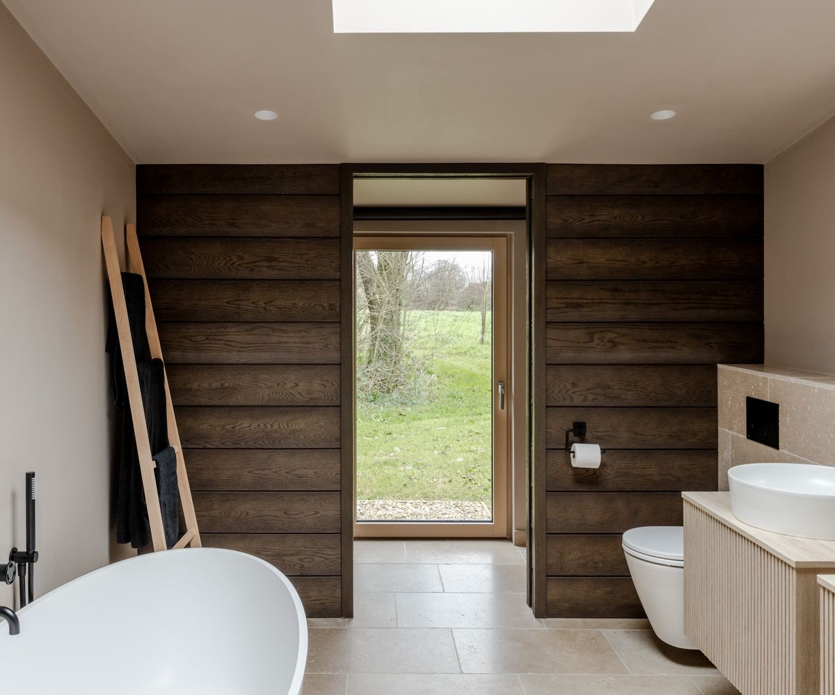 A bathroom with a standalone bath and rooflight