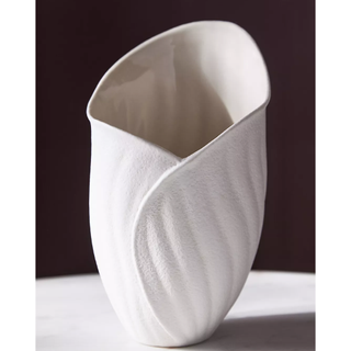 white stoneware vase in the shape of a curled up flower bud