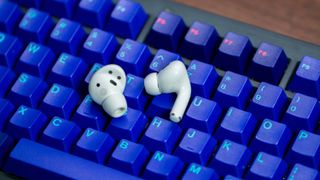 Samsung Galaxy Buds 2 Pro and AirPods Pro 2 earbud on keyboard