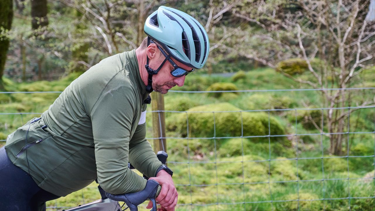 Rider rests arms on handlebars looking tired