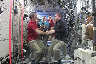 Canadian astronaut Chris Hadfield (left) accepts command of the International Space Station from NASA astronaut and out-going station commander Kevin Ford, March 13, 2013.