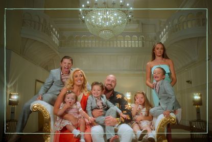 Tyson Fury and his family sat on a sofa in the mansion where they live