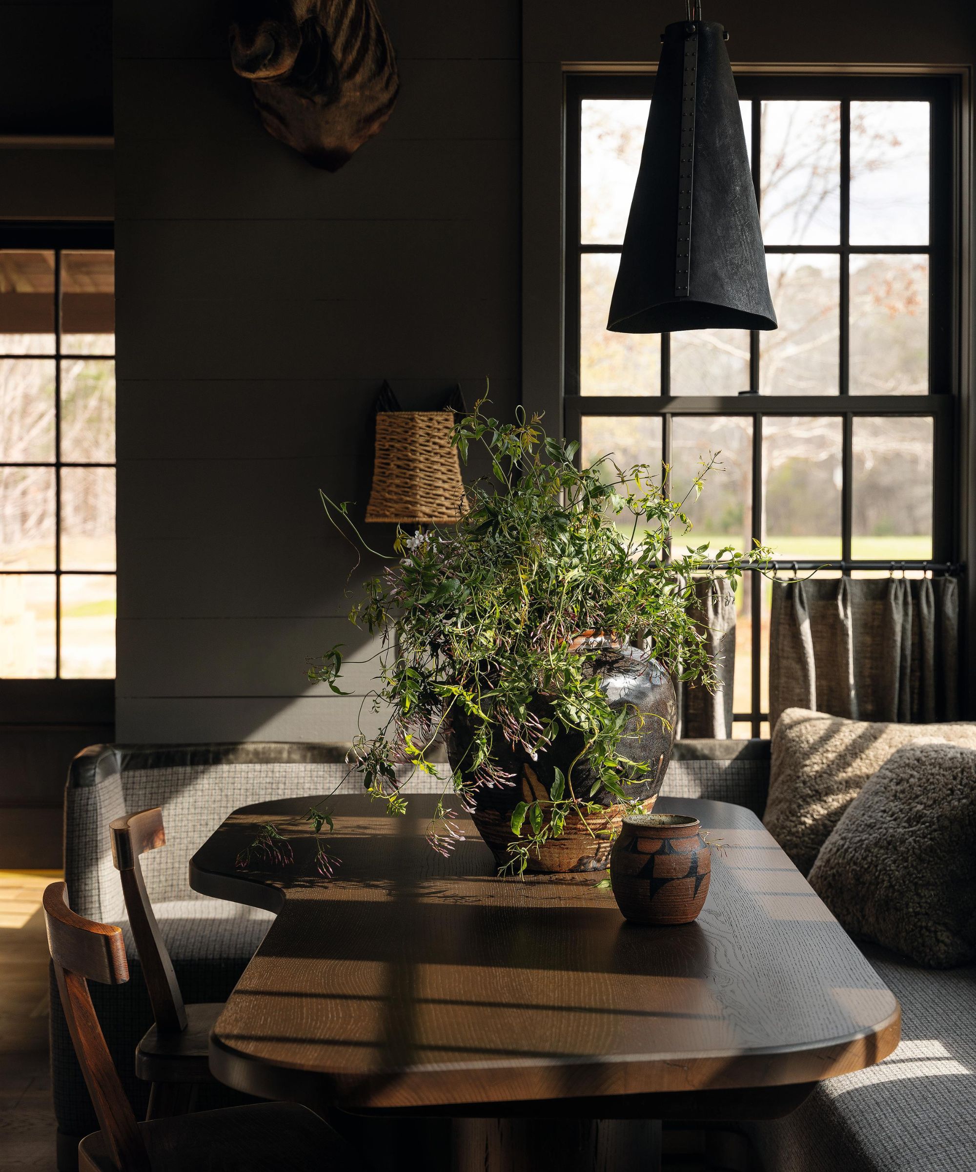 a moody wood clad dining nook in a farmhouse home