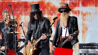 Slash and Billy Gibbons in their trademark headwear, playing the CMT Music Awards 2023