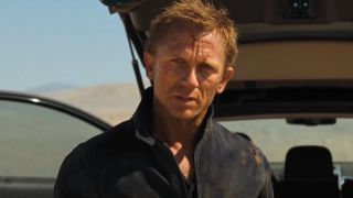 Daniel Craig stands with a determined expression, in front of his car trunk, in Quantum of Solace.