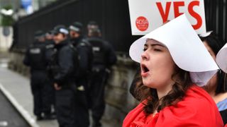 Woman in red protesting