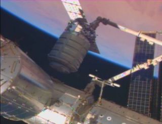 The robotic Cygnus resupply ship built by Orbital Sciences Corp. is moved into docking position with the International Space Station as both vehicles sail over Africa on Jan. 12, 2014. The Orb-1 Cygnus mission is delivering 2,780 pounds (1,260 kilograms)