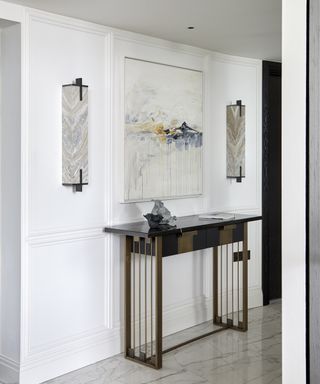 A modern hallway idea with mid-century modern style wall sconces and console table