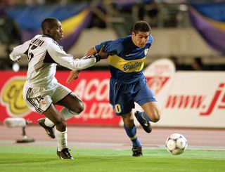 Juan Riquelme of Boca Juniors is tackled by Geremi of Real Madrid during the Toyota Intercontinental Cup against Real Madrid in the National Stadiu,Tokyo,Japan.Boca Juniors won the match 2-1