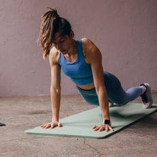 Plank everyday for a week: A woman doing a plank at home