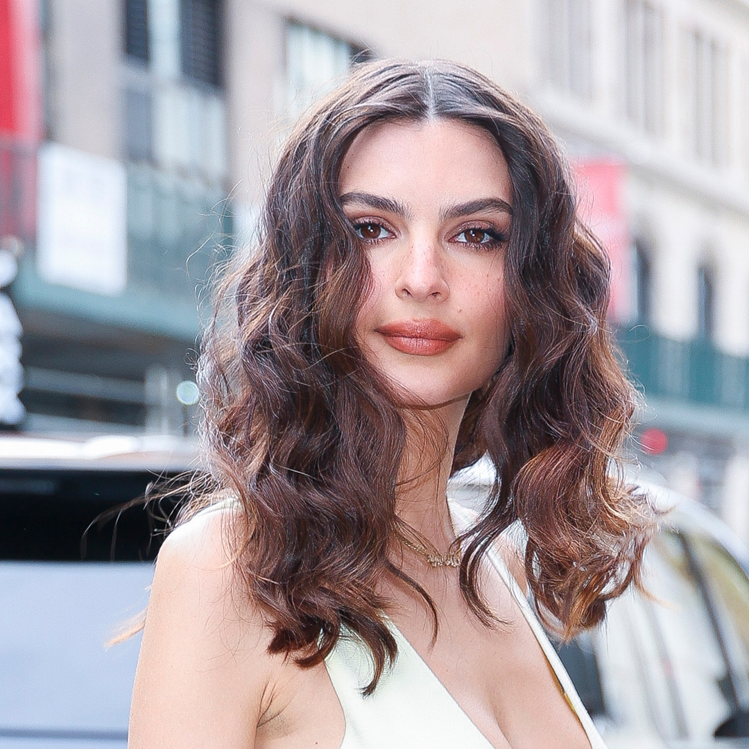 Emily Ratajkowski with curly hair and a halter-neck dress.