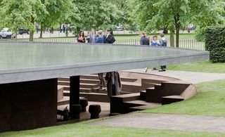 Close up of exterior of structure at Serpentine Gallery with metal roof filled with water and cork covered steps and walls