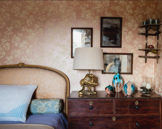 Bedroom with warm walls and wooden dresser