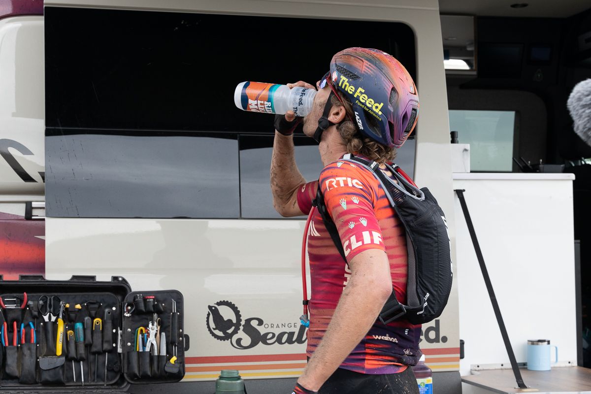 Peter Stetina quckly drinks a bottle before he heads back out on course.