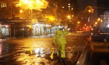 A Con Edison worker walks through the flood waters in front of NYU Langone Medical Center in midtown Manhattan during Hurricane Sandy on Oct. 29.
