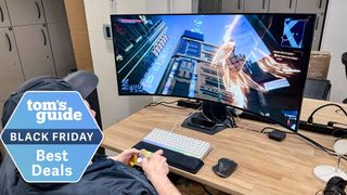 Black Friday monitor deals tag superimposed over photo of man playing game on Samsung curved ultrawide monitor