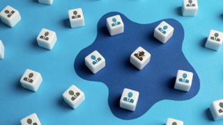 Dice with a symbol depicting a hacker surrounded by dice representing employees 