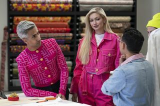 Hosts Tan France and Gigi Hadid wearing pink outfits