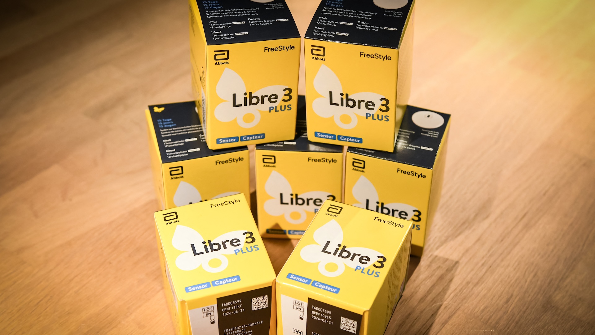 a pyramid of stacked Freestyle Libre 3 Plus sensors in yellow boxes