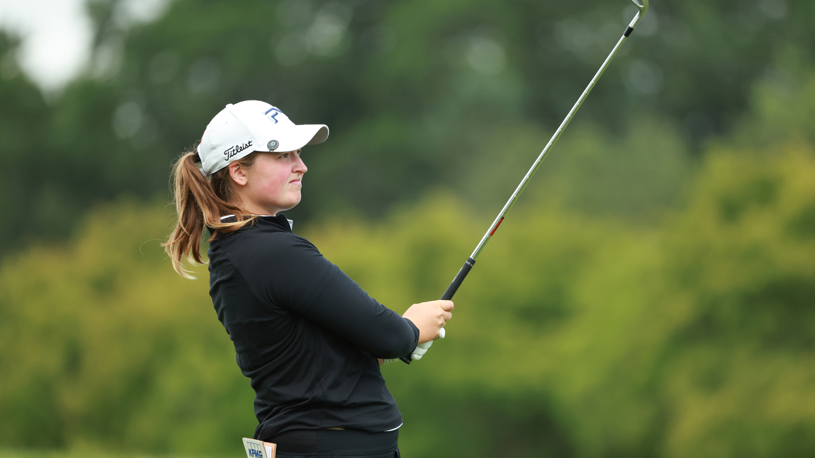 Lottie Woad hits an iron into the green