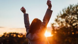 A woman holding her hands in the air