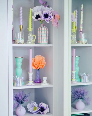 Two white shelving unit with colorful decorations