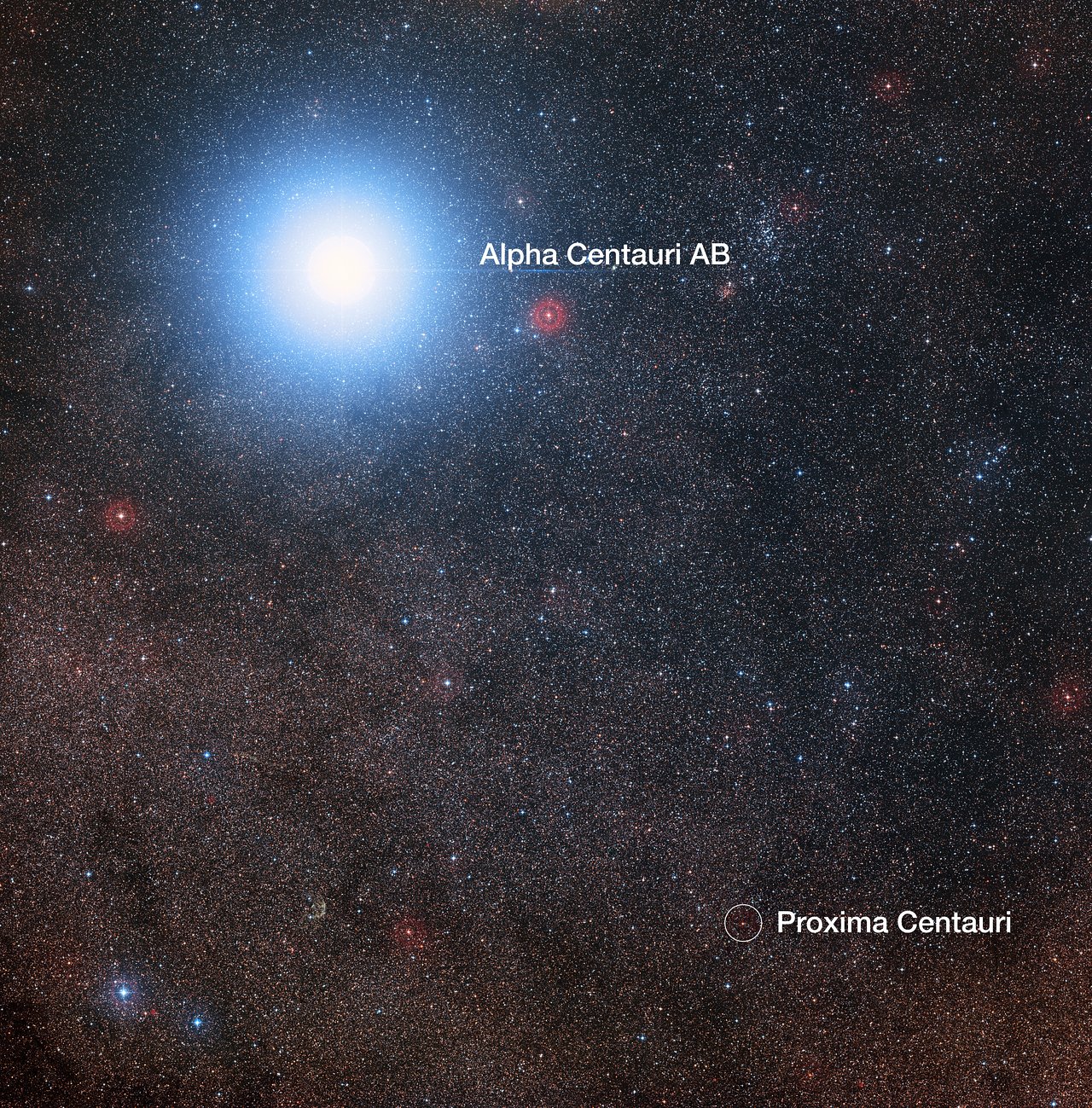 This image of the sky around the bright star Alpha Centauri AB also shows the much fainter red dwarf star, Proxima Centauri, the closest star to our solar system. The photo was created from pictures forming part of the Digitized Sky Survey 2. The blue halo around Alpha Centauri AB is an artifact of the photographic process; the star is actually pale yellow in color like our sun.