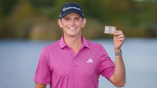 Jacob Bridgeman poses for a photo with his PGA Tour card in 2023