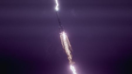 Photo of the rocket in the air with lightning striking the rocket